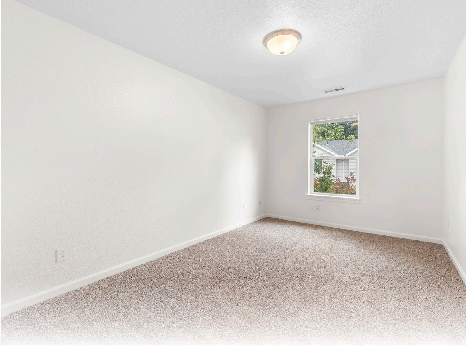 Carpeted bedroom with natural light