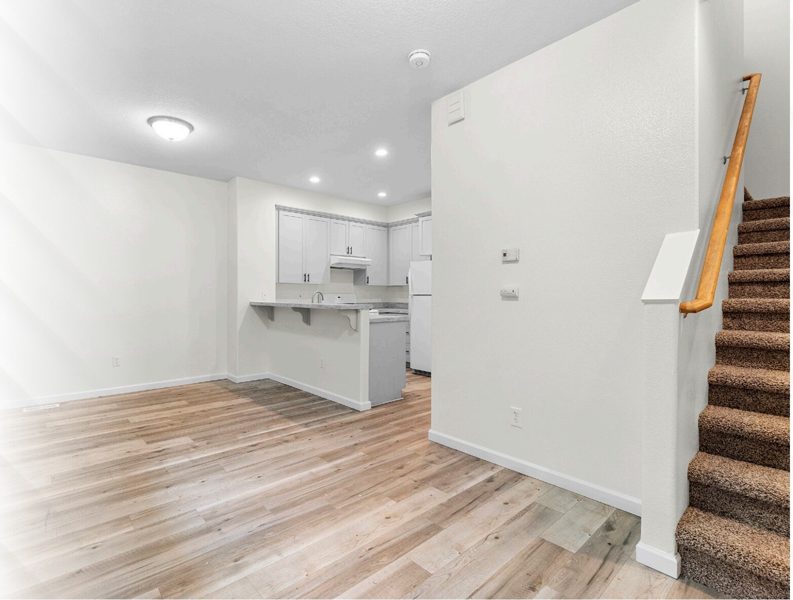Kitchen with white cabinetry and appliances